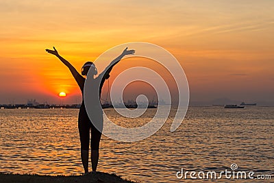 Silhouette women runner listening music and feeling freedom, happy and enjoying nature sunset. Stock Photo