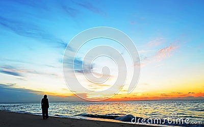 Silhouette woman,sunset on ocean Amity Point beach, North Stradbroke Island,Australia Stock Photo