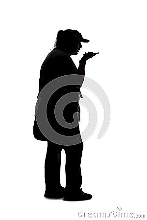 Silhouette of a Woman Using a Cellphone or Smart Phone Stock Photo