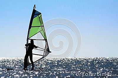 Silhouette of a woman windsurfer Stock Photo