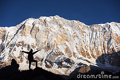 Silhouette women backpacker on the rock and Annapurna I Background 8,091m from Annapurna Basecamp ,Nepal. Stock Photo