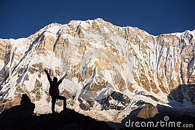 Silhouette women backpacker on the rock and Annapurna I Background 8,091m from Annapurna Basecamp ,Nepal. Stock Photo