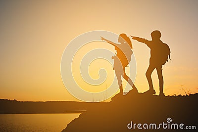 Silhouette women and girl backpacker on the top mountain Stock Photo