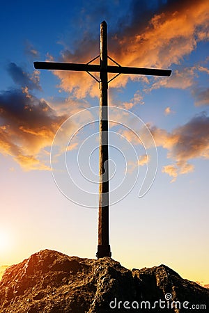 Silhouette wooden cross on the summit of a mountain. Stock Photo