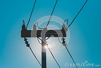 Silhouette wooden electric pole and power lines with sunset in the background at countryside. Stock Photo