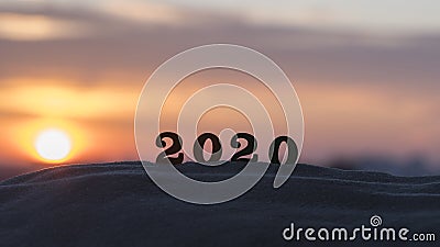 Silhouette of 2020 wooden numbers on the sand on the beach at sunset. Setting sun. The symbol of the outgoing year. 2021. Stock Photo