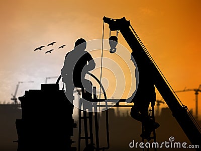 Silhouette worker on construction site over Blurred construction Stock Photo
