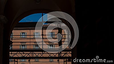 Silhouette of workman standing on scaffold in archway Editorial Stock Photo