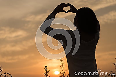 Silhouette of a young asian woman Stock Photo