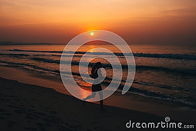 Silhouette young female runner,running at sunset on sea Editorial Stock Photo