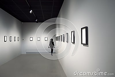 Silhouette of young girl at art exhibition Stock Photo