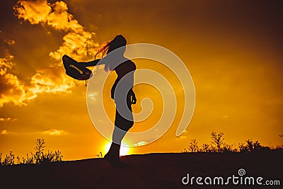 Silhouette of a young girl in t-shirt and shorts Stock Photo