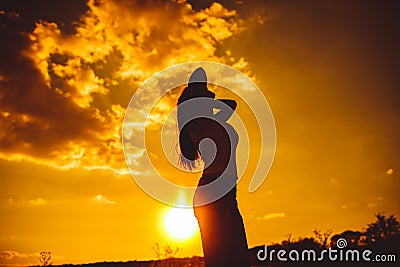 Silhouette of a young girl in a vest and shorts Stock Photo