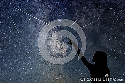 Silhouette of young girl watching Meteor Shower. Stock Photo