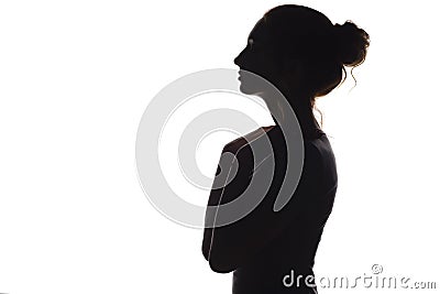 Silhouette of a young graceful woman on a white isolated background, face profile of a beautiful girl Stock Photo