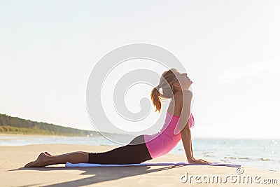 Silhouette of young healthy and fit woman practicing yoga Stock Photo