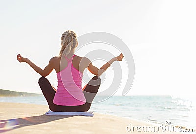 Silhouette of young healthy and fit woman practicing yoga Stock Photo