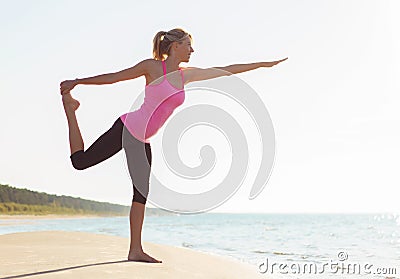 Silhouette of young healthy and fit woman practicing yoga Stock Photo