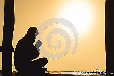 Silhouette of young human hands praying to god at sunrise, Christian Religion concept background Stock Photo