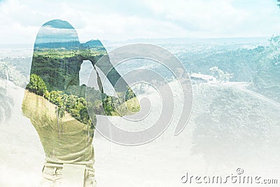 A silhouette of the young lady who is taking a landscape picture. Stock Photo