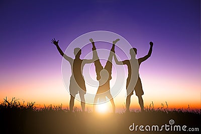 The Silhouette of young people catching a handstand person Stock Photo