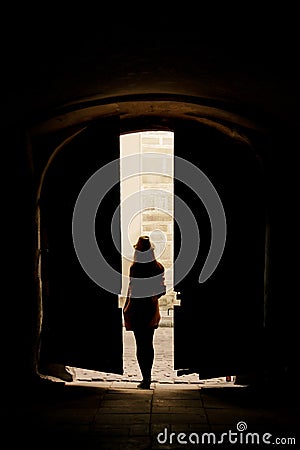 silhouette of young woman hipster walking in the street of an o Stock Photo