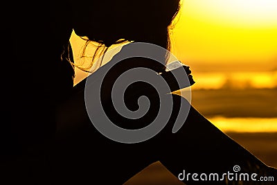 Silhouette woman praying to God in the nature at sunset, the concept of religion and spirituality Stock Photo