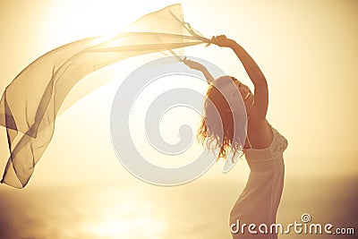 Silhouette of young woman relaxing at the beach Stock Photo