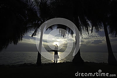 Silhouette of young woman, standing alone by the sea, fitness on the dam Stock Photo