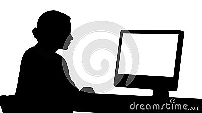 Silhouette Young woman working in office, sitting at desk, looking at monitor. Stock Photo