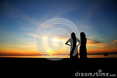 Silhouette young women on the beach Stock Photo