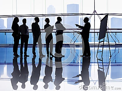 Silhouetted group of business people Stock Photo