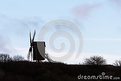 Silhouetted old wooden windmill Stock Photo