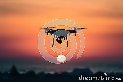 Silhouetted quadcopters against sunrise sky, capturing aerial views Stock Photo