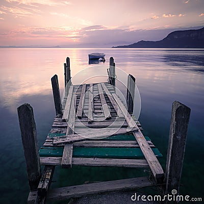 Silhouetted rowing boat on Lake Garda, Italy Stock Photo