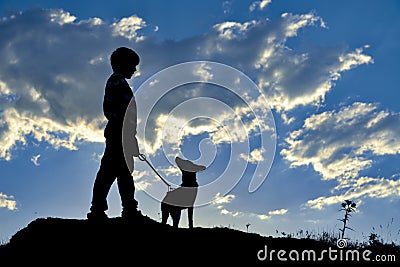 Boy with dog on hill Stock Photo