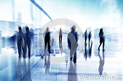 Silhouettes of Business People in Blurred Motion Walking Stock Photo