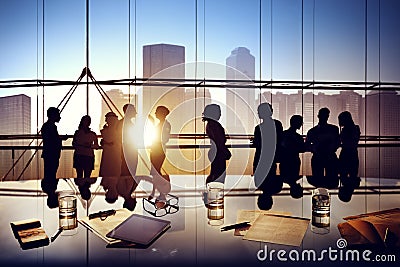 Silhouettes of Business People Brainstorming Inside the Office Stock Photo