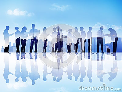 Silhouettes of Business People Communicating in a Cityscape Stock Photo