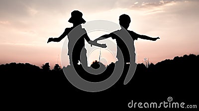 Silhouettes of children jumping off a cliff at sunset Stock Photo