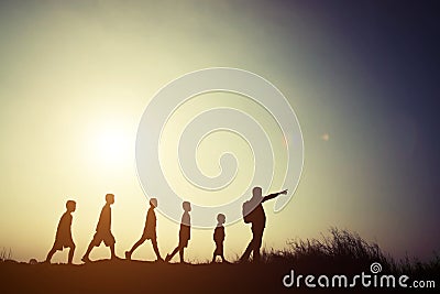 Silhouettes children and parent walking with backpacks. Time to Stock Photo