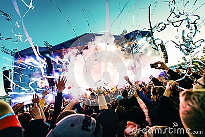 Silhouettes of concert crowd in front of bright stage lights Editorial Stock Photo