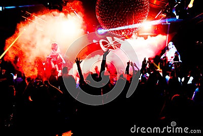 silhouettes of concert crowd in front of bright stage lights Editorial Stock Photo