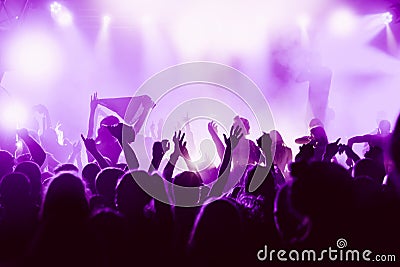 Silhouettes of the concert crowd in front of bright stage lights Editorial Stock Photo