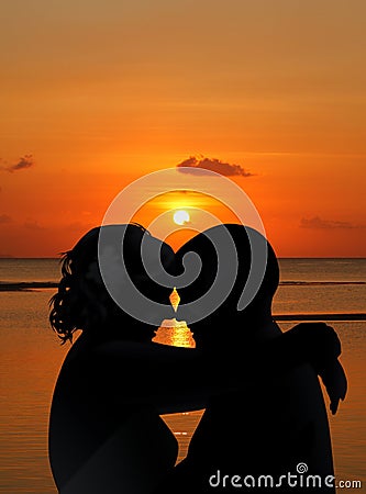 Silhouettes Couple on sunset beach Stock Photo