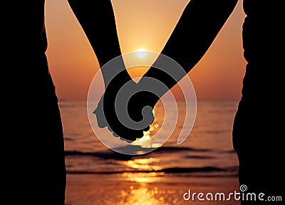 Silhouettes couples holding hands Stock Photo