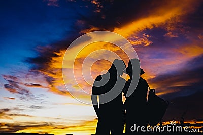 Silhouettes couples with sunset Stock Photo