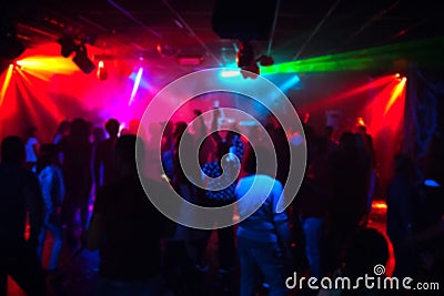 Silhouettes of a crowd of people dancing in a nightclub on the dance floor at a party Editorial Stock Photo