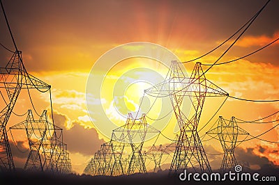 Silhouettes of electricity transmission pole in sunset Stock Photo