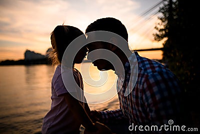 Silhouettes of father and little daughter looking at each other Stock Photo
